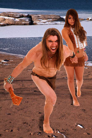 A native couple in the outdoors walking away from the lake.の写真素材