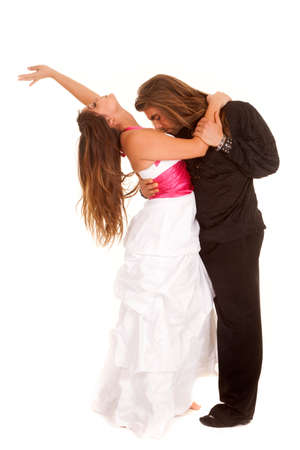 a couple dancing and the woman is leaning back as he leans forward to kiss her chest.の写真素材