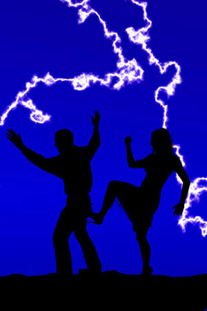 A silhouette of woman kicking her man forward.の写真素材