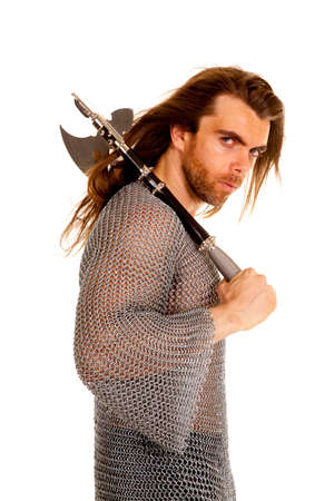 A man in his chain mail with a serious expression on his face holding onto his axe.の写真素材
