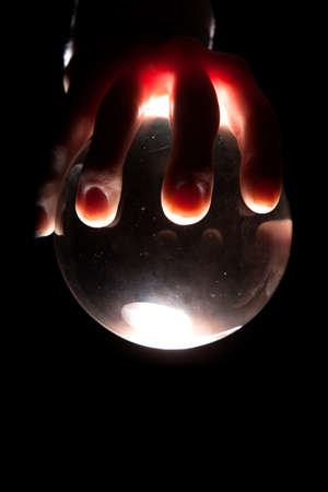 A person holding on to a magic lighted ball.の写真素材