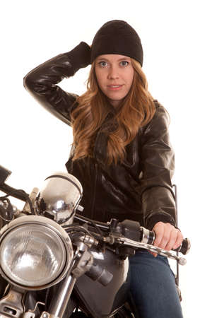 a woman on a motorcycle in her leather jacket and hatの写真素材