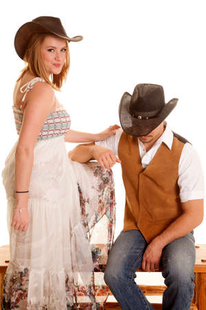 A cowboy is leaning on a cowgirl's knee.の写真素材