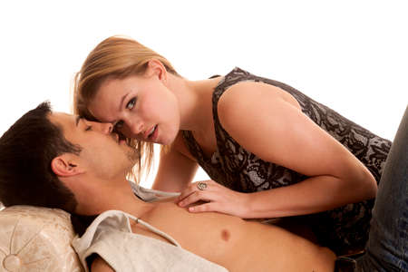 A woman is laying on a man and looking up.の写真素材