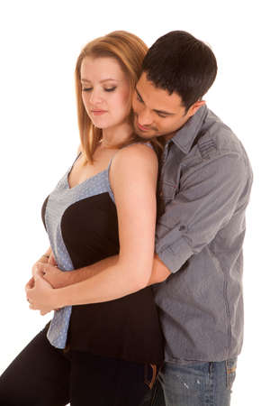 A couple is standing together with their eyes looking down.の写真素材