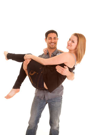 A man is holding a woman in his arms. の写真素材