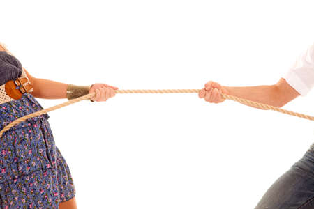 A close up of a man and woman doing a tug of war with a rope.