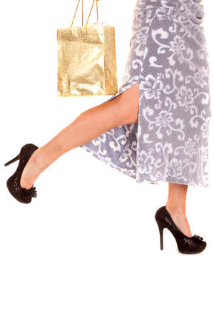 A woman in a skirt legs only with a shopping bag.の写真素材