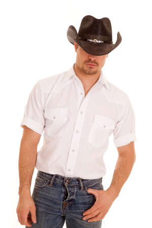 a cowboy hiding his eyes with his hat.の写真素材