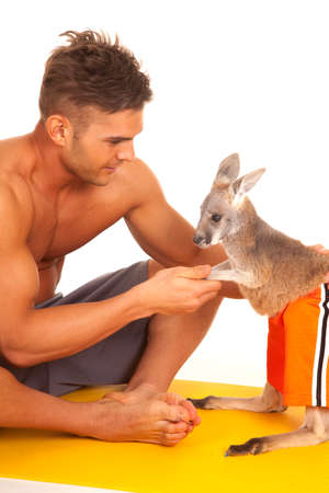 a man on his fitness mat holding on to his kangaroo.の写真素材