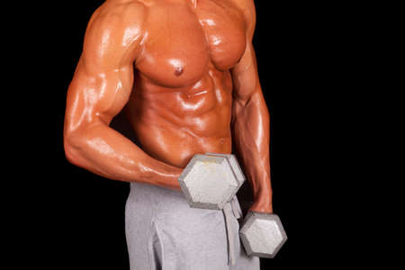 A close up of a man working out with weights.の写真素材