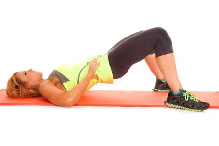 An older woman laying on her back hips in the air fitness.の写真素材
