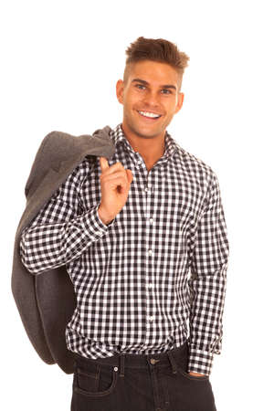 A man holding on to his suitcoat with a smile on his face.の写真素材