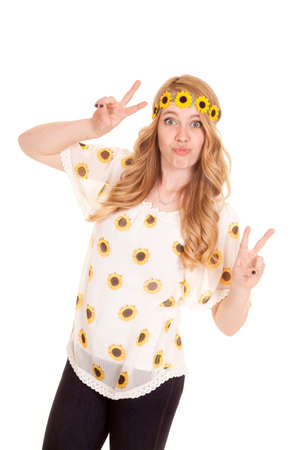 a woman in her sunflower shirt and headband doing the peace sign.の写真素材