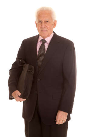 An elderly business man standing in a suit.の写真素材