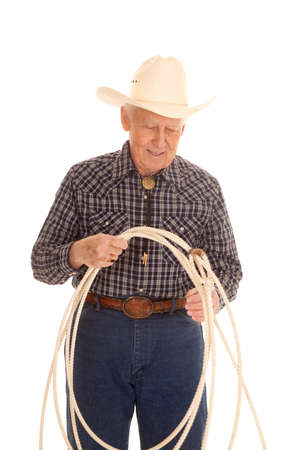 An elderly man with a rope and a cowboy hat.の写真素材