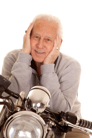 An elderly man sitting on a motorcycle.の写真素材