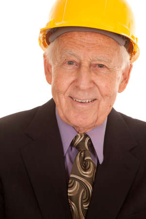 An elderly man in a suit and a hard hat.の写真素材