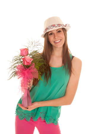 a woman with a smile on her face holding on to her roses.の写真素材