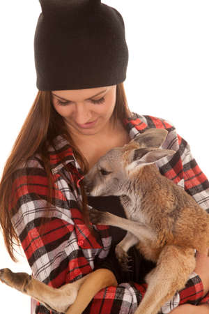 A woman looking down at her baby kangaroo.の写真素材
