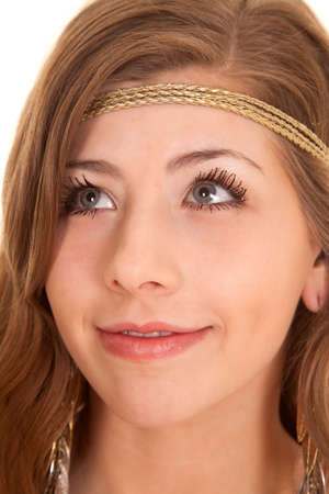 A close up of a woman in her headband and earings smiling.の写真素材
