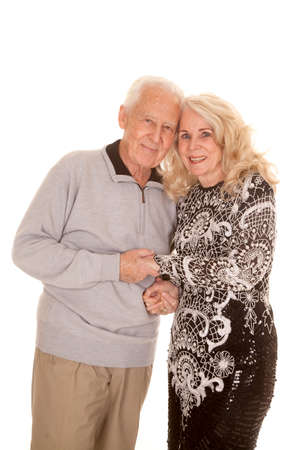 an elderly couple holding each other with their heads together.の写真素材