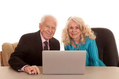 An older couple business people working together on a laptop.の写真素材
