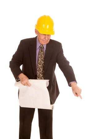a elderly man in his hard hat holding on to his construction plans.の写真素材