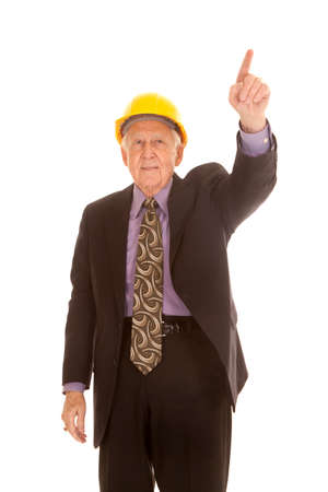 an elderly man pointing his finger up while wearing his hard hat.の写真素材