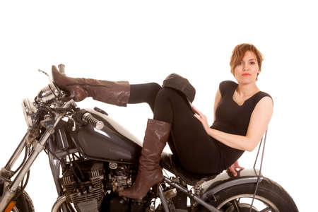A woman is sitting on a motorcycle looking sexy.の写真素材