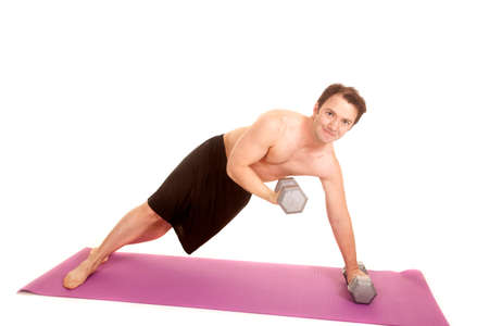 A man is on his side curling some weights.の写真素材