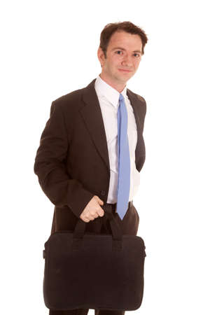 a business man holding a bag looking serious.の写真素材
