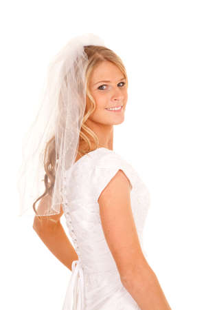 A woman in a veil and wedding dress with a smile.の写真素材