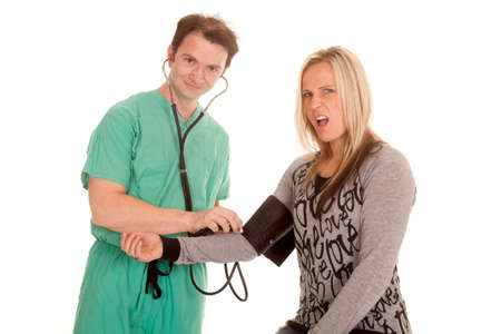 A woman is getting her blood pressure checked.