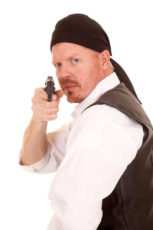 A man is looking back aiming a gun.の写真素材