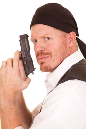 A man with a gun in his hands looking.の写真素材