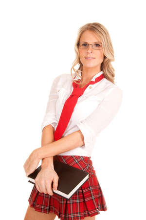 A woman in a school girl outfit holding a bookの写真素材