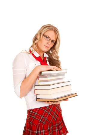 A school girl looking with a big stack of books.の写真素材