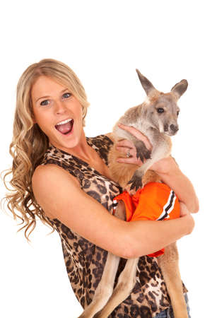 a woman with a big smile on her face holding on to her kangaroo.の写真素材