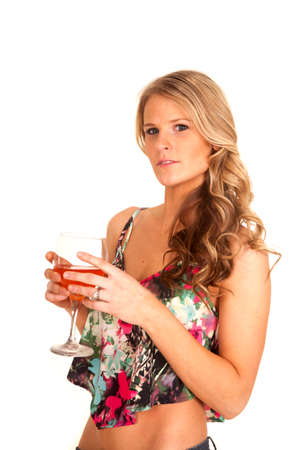 A woman looking holding on to her wine glass.の写真素材