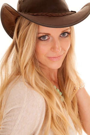 a close up of a woman in a cowgirl hat looking.の写真素材