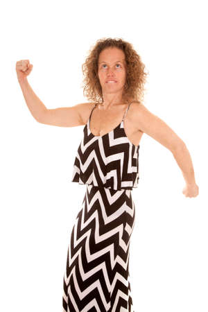 A woman in her dress flexing her arms.の写真素材