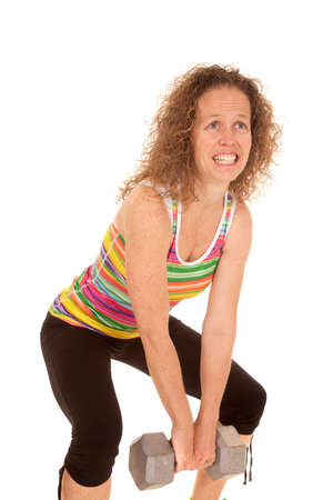 a woman having a hard time lifting her weight.の写真素材