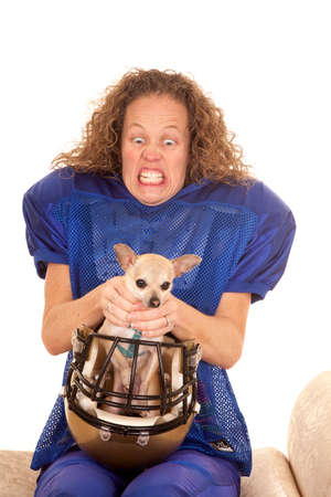 a woman with a crazy expression on her face finding a dog in her helmet.の写真素材