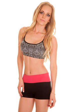A woman in her fitness clothing showing off her fit body.の写真素材