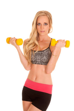 a woman doing an arm curl with a seductive expression on her faceの写真素材