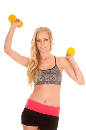 a woman working out with yellow weights.の写真素材