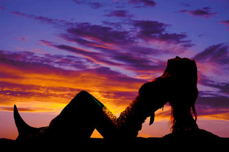 a silhouette of a mermaid leaning back.