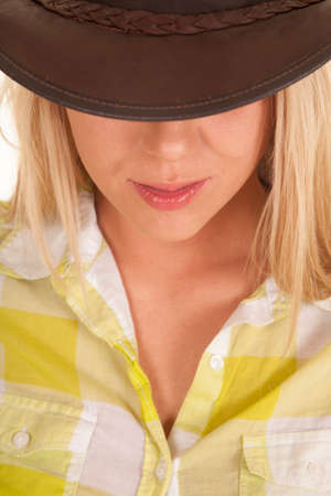 A close up of a woman in her cowgirl hat with her eyes hidden.の写真素材