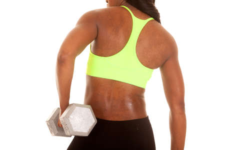 a African American woman showing off her back. She is working out with weights.の写真素材
